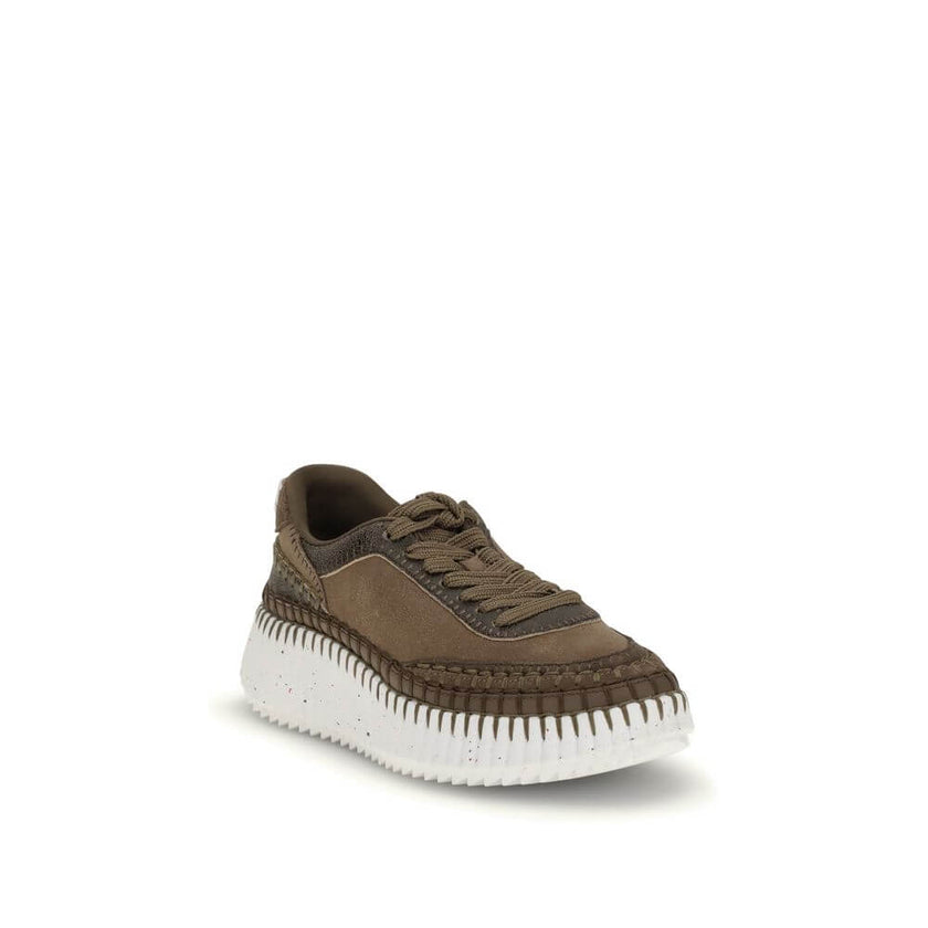 Nama SneakersThe Nama Sneakers by Chloé are made from a mix of suede calfskin and cracked shearling leather. They feature an iconic sole made of recycled materials, lightweight and ultra-comfortable, with a dotted effect. Finished with delicate saddle sti