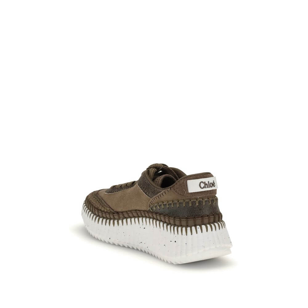 Nama SneakersThe Nama Sneakers by Chloé are made from a mix of suede calfskin and cracked shearling leather. They feature an iconic sole made of recycled materials, lightweight and ultra-comfortable, with a dotted effect. Finished with delicate saddle sti