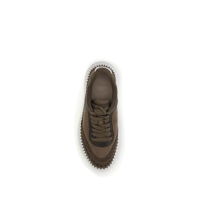 Nama SneakersThe Nama Sneakers by Chloé are made from a mix of suede calfskin and cracked shearling leather. They feature an iconic sole made of recycled materials, lightweight and ultra-comfortable, with a dotted effect. Finished with delicate saddle sti