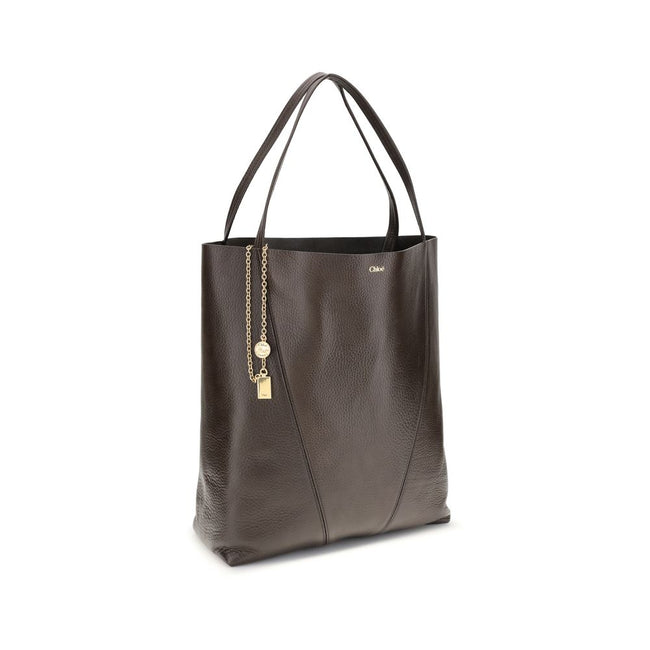 Brown Calf Leather Bos Taurus Shoulder BagChloé’s Spin Large Tote Bag is crafted in glossy garnet cowhide and features a minimalist silhouette with graphic and elegant lines. A distinctive detail is the hanging chain with Chloé medals and the Horse emblem