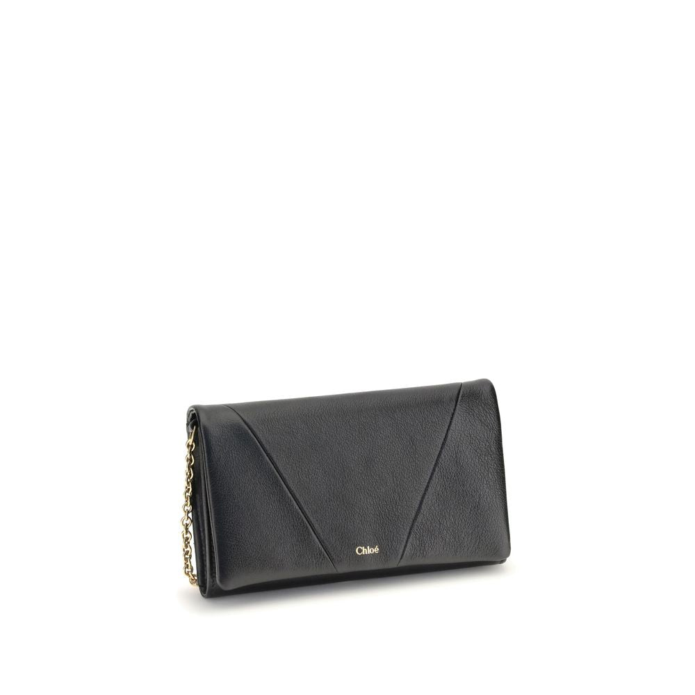 Black Calf Leather Bos Taurus WalletThe Spin Wallet with Flap and Chain by Chloé is crafted from garnet buffalo leather with an interior of buffalo leather and a polyester-cotton blend fabric. Equipped with a chain shoulder strap, it can be worn crossbody