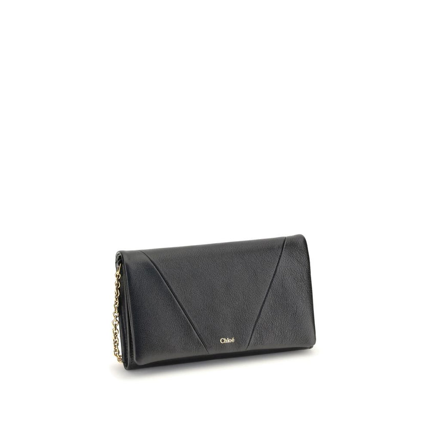 Black Calf Leather Bos Taurus WalletThe Spin Wallet with Flap and Chain by Chloé is crafted from garnet buffalo leather with an interior of buffalo leather and a polyester-cotton blend fabric. Equipped with a chain shoulder strap, it can be worn crossbody