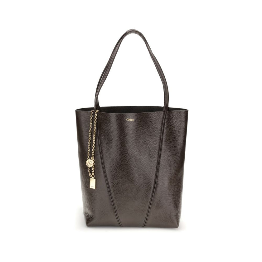 Brown Calf Leather Bos Taurus Shoulder BagLeather Spin Shoulder Bag by Chloé is a refined and modern accessory featuring a sleek grained leather design. The two flat top handles offer a comfortable and practical grip, while the brand’s iconic monogram, pr