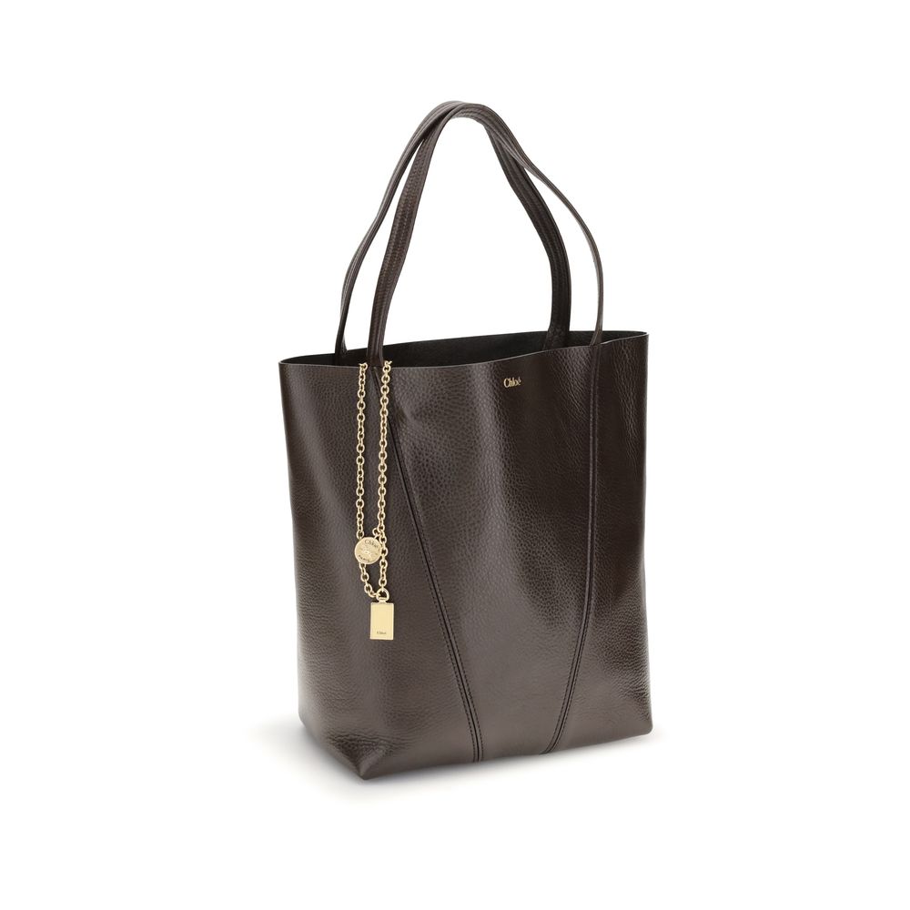 Brown Calf Leather Bos Taurus Shoulder BagLeather Spin Shoulder Bag by Chloé is a refined and modern accessory featuring a sleek grained leather design. The two flat top handles offer a comfortable and practical grip, while the brand’s iconic monogram, pr