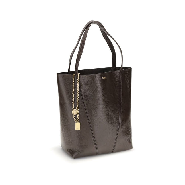 Brown Calf Leather Bos Taurus Shoulder BagLeather Spin Shoulder Bag by Chloé is a refined and modern accessory featuring a sleek grained leather design. The two flat top handles offer a comfortable and practical grip, while the brand’s iconic monogram, pr