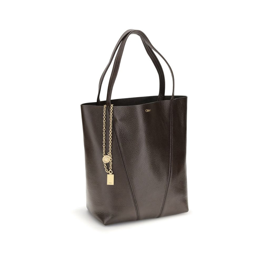 Brown Calf Leather Bos Taurus Shoulder BagLeather Spin Shoulder Bag by Chloé is a refined and modern accessory featuring a sleek grained leather design. The two flat top handles offer a comfortable and practical grip, while the brand’s iconic monogram, pr