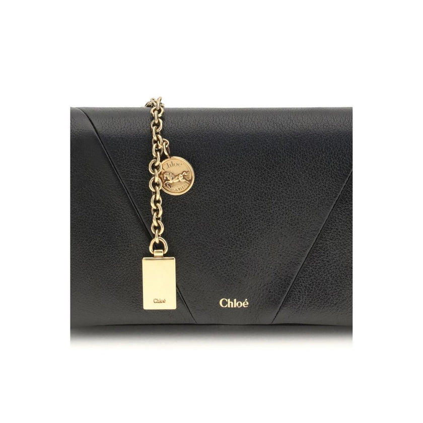 Black Calf Leather Bos Taurus WalletThe Spin Wallet with Flap and Chain by Chloé is crafted from garnet buffalo leather with an interior of buffalo leather and a polyester-cotton blend fabric. Equipped with a chain shoulder strap, it can be worn crossbody
