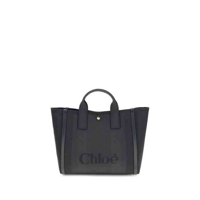 Black Cotton HandbagChloé’s Carry Handbag is a refined and versatile accessory made of cotton with contrasting leather details that accentuate its elegance. The snap top closure provides practicality, while the double flat handles and leather extension on