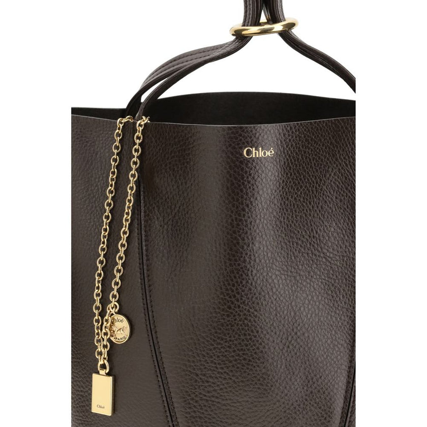 Brown Calf Leather Bos Taurus Shoulder BagLeather Spin Shoulder Bag by Chloé is a refined and modern accessory featuring a sleek grained leather design. The two flat top handles offer a comfortable and practical grip, while the brand’s iconic monogram, pr