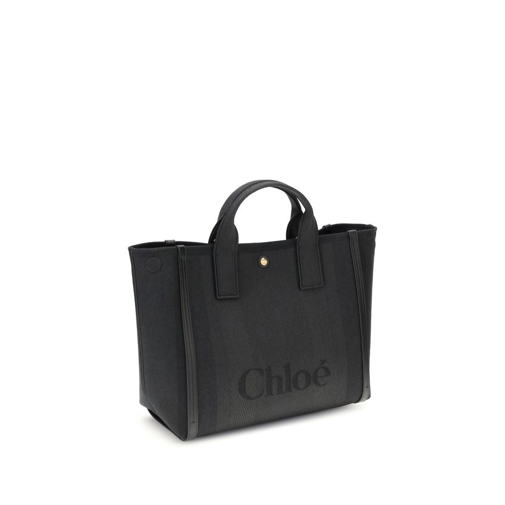 Black Cotton HandbagChloé’s Carry Handbag is a refined and versatile accessory made of cotton with contrasting leather details that accentuate its elegance. The snap top closure provides practicality, while the double flat handles and leather extension on