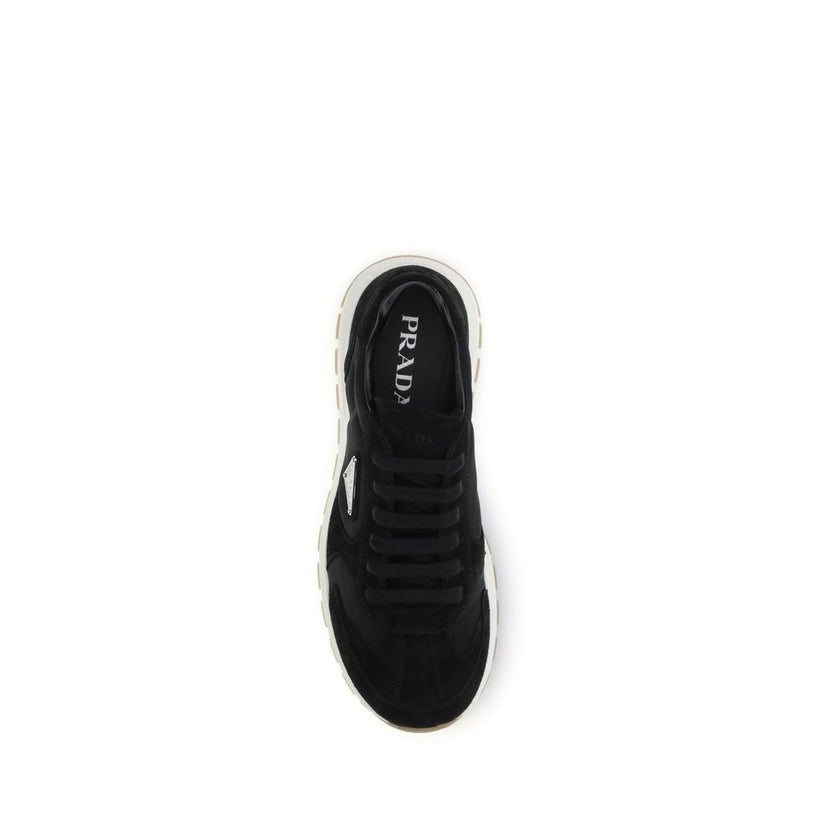 Black Recycled Polyamide Athletic SneakersPrax 01 re-nylon Sneakers by Prada blend contemporary aesthetics and innovative materials. The upper with nylon lace loops lends a technical, modern look, enhanced by the enameled metal triangle logo and screen-pr