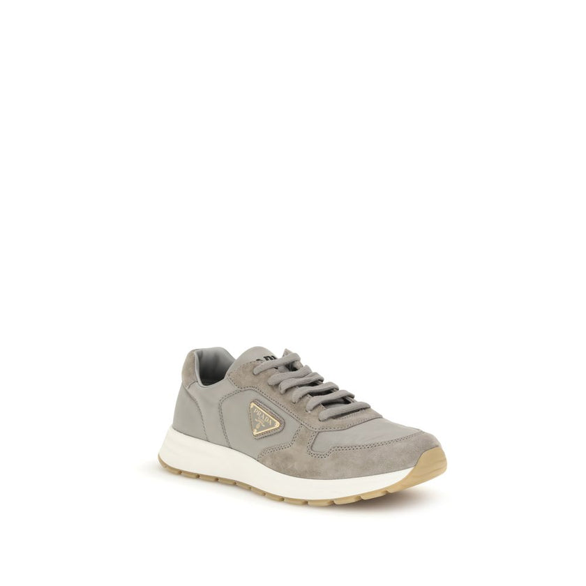 Gray Recycled Polyamide Athletic SneakersPrax 01 re-nylon Sneakers by Prada blend contemporary aesthetics and innovative materials. The upper with nylon lace loops lends a technical, modern look, enhanced by the enameled metal triangle logo and screen-pri