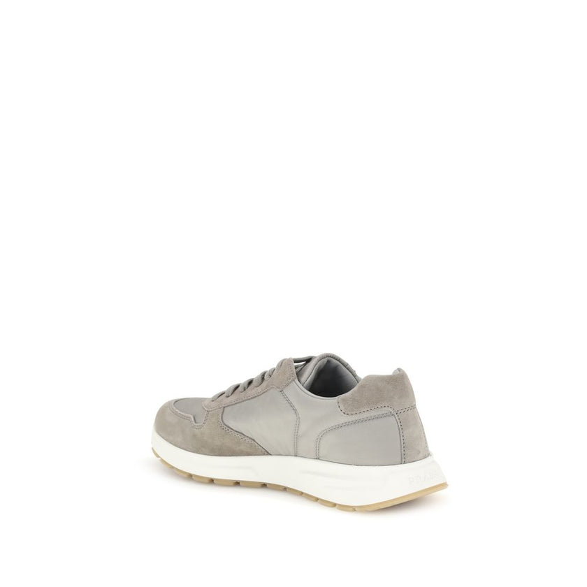 Gray Recycled Polyamide Athletic SneakersPrax 01 re-nylon Sneakers by Prada blend contemporary aesthetics and innovative materials. The upper with nylon lace loops lends a technical, modern look, enhanced by the enameled metal triangle logo and screen-pri