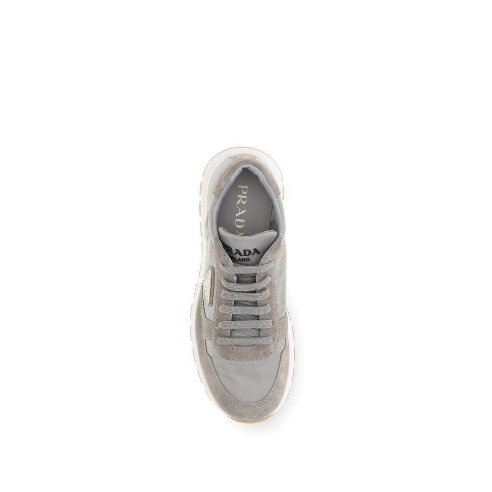 Gray Recycled Polyamide Athletic SneakersPrax 01 re-nylon Sneakers by Prada blend contemporary aesthetics and innovative materials. The upper with nylon lace loops lends a technical, modern look, enhanced by the enameled metal triangle logo and screen-pri