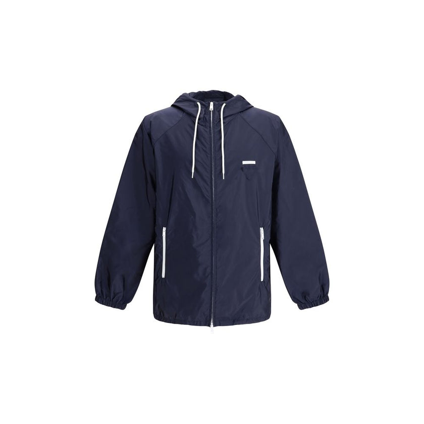 Blue Recycled Polyamide Shell JacketPrada’s Re-Nylon Jacket is a functional and refined garment designed for modern, sustainable elegance. Featuring an adjustable hood with drawstring and front closure with a double-slider zipper, it has two side welt poc