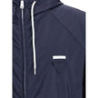 Blue Recycled Polyamide Shell JacketPrada’s Re-Nylon Jacket is a functional and refined garment designed for modern, sustainable elegance. Featuring an adjustable hood with drawstring and front closure with a double-slider zipper, it has two side welt poc