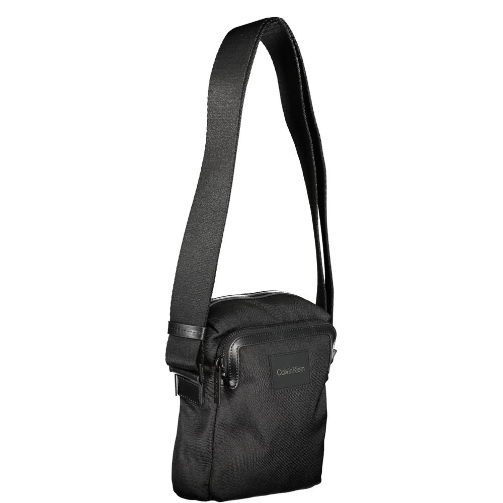 Black Polyester HandbagADJUSTABLE SHOULDER STRAP, 2 EXTERNAL POCKETS, 1 INTERNAL COMPARTMENT FOR I-PAD HOLDER, ZIP CLOSURE, LOGO, 95% POLYESTER RECYCLEDBlack Polyester Handbag${tagsCalvin KleinAulae Black Polyester Handbag Calvin KleinAulae Black Polyeste