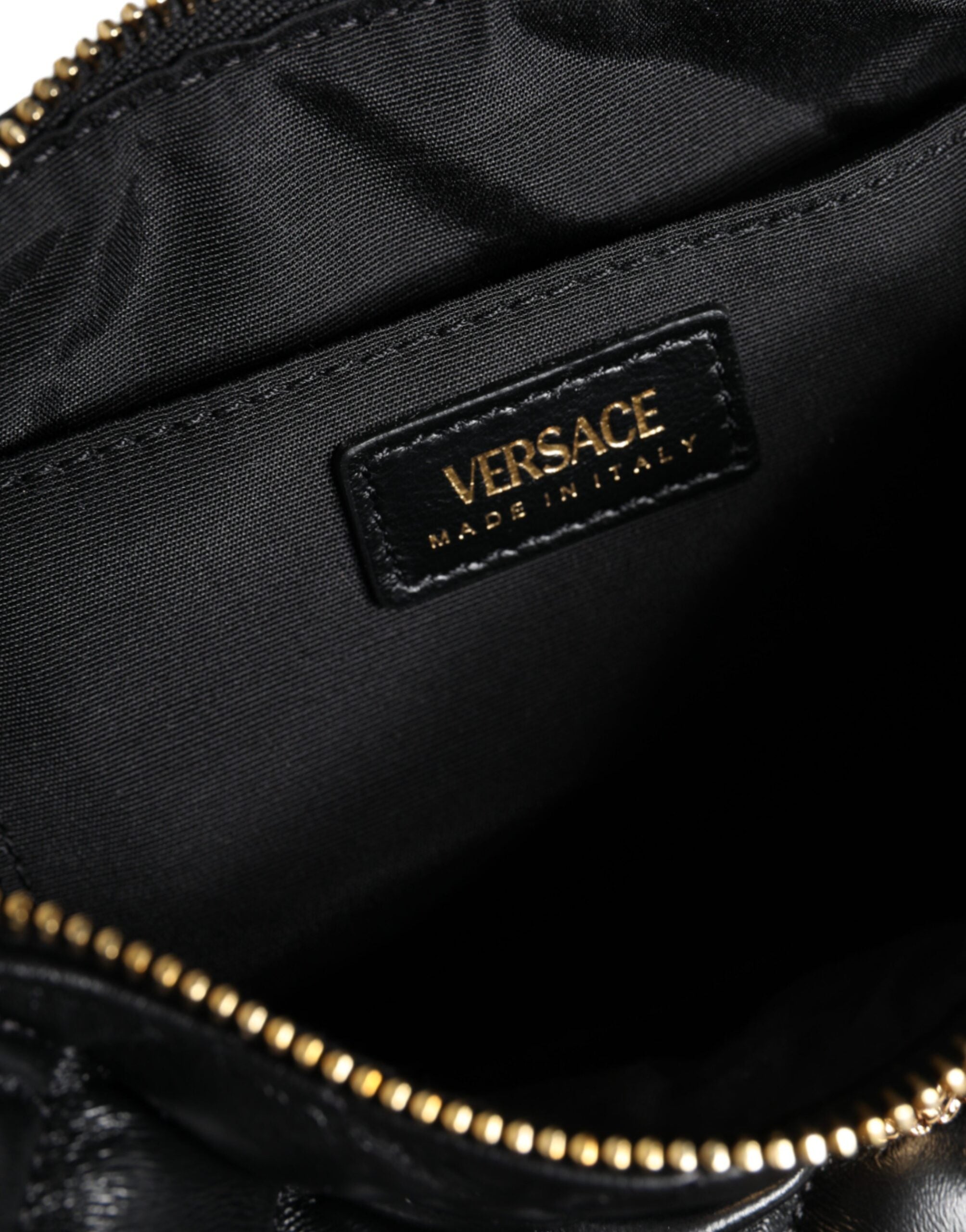 Black Mini Quilted Lambskin Leather Crossbody Sling Borse BagVERSACE Absolutely stunning, 100% Authentic brand new Versace bag. Brand logo, solid color, crossbody strap, and zipper fastening.Model: Crossbody bagColor: BlackMaterial: AOS 100%, 60% Cotton,