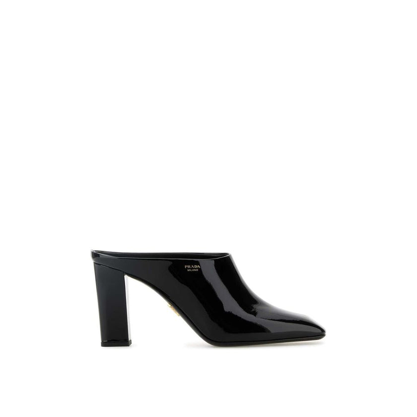 Black Calfskin MulesDescription: – Composition: 100% calf leather – Inner: Leather – Insole: Leather – Sole: Leather – Patent effect – Square toe – Branded insole – Side logo detail – Open back – Heel 8,5 cm – Made in Italy – Gender: WOMEN –Black Calfskin
