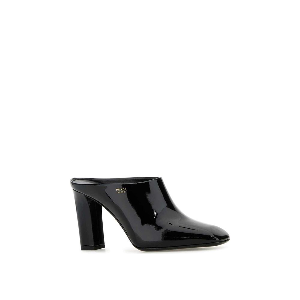Black Calfskin MulesDescription: – Composition: 100% calf leather – Inner: Leather – Insole: Leather – Sole: Leather – Patent effect – Square toe – Branded insole – Side logo detail – Open back – Heel 8,5 cm – Made in Italy – Gender: WOMEN –Black Calfskin