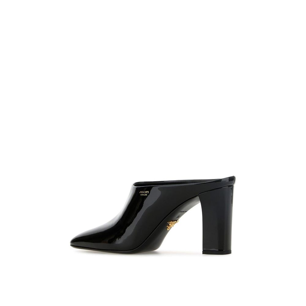 Black Calfskin MulesDescription: – Composition: 100% calf leather – Inner: Leather – Insole: Leather – Sole: Leather – Patent effect – Square toe – Branded insole – Side logo detail – Open back – Heel 8,5 cm – Made in Italy – Gender: WOMEN –Black Calfskin