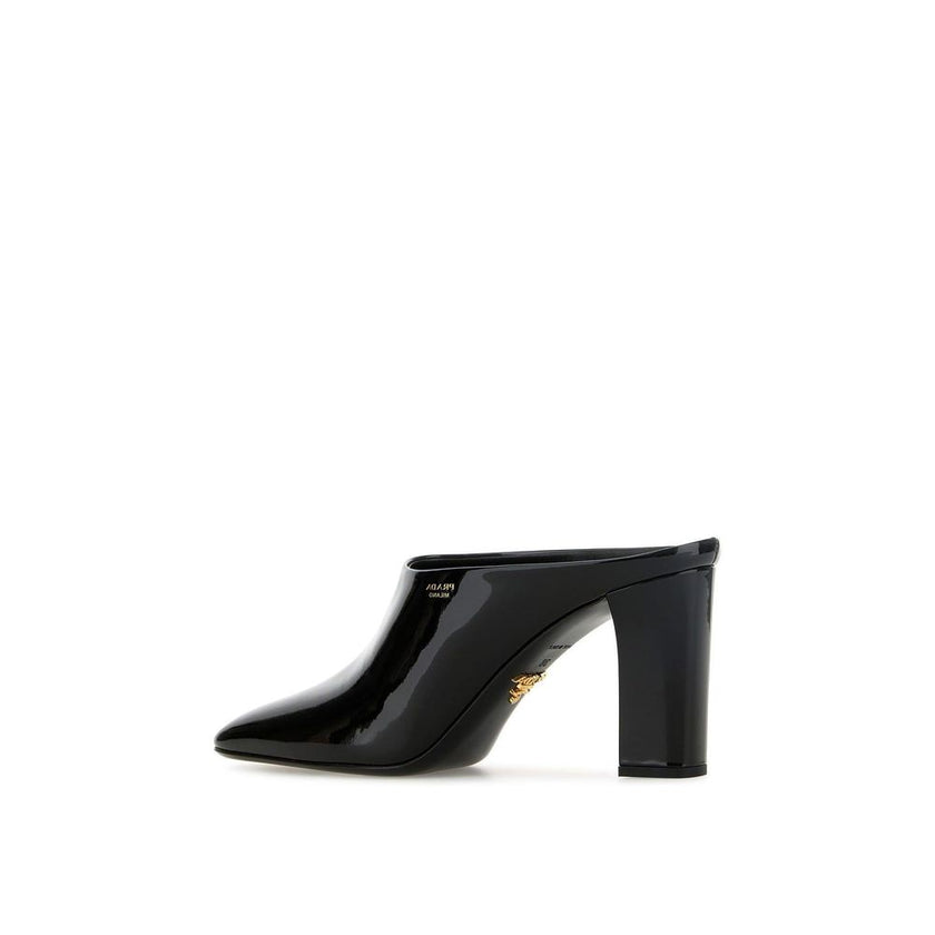 Black Calfskin MulesDescription: – Composition: 100% calf leather – Inner: Leather – Insole: Leather – Sole: Leather – Patent effect – Square toe – Branded insole – Side logo detail – Open back – Heel 8,5 cm – Made in Italy – Gender: WOMEN –Black Calfskin