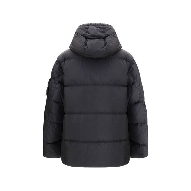 Hooded Down JacketStone Island’s hooded Down Jacket combines functionality with distinctive technical style. The padded hood is adjustable via drawstring for a perfect fit, while the two exterior pockets offer practical solutions: one with a top opening,
