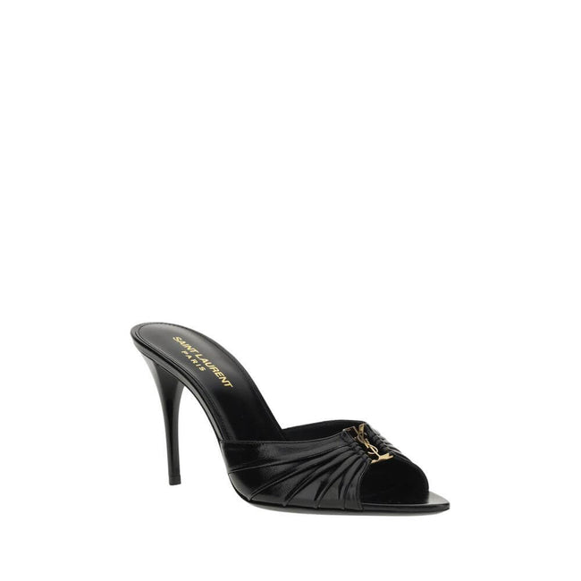 Babylone SandalsSaint Laurent’s soft lambskin Babylone Sandals are the epitome of sophisticated femininity. Featuring a refined almond toe, they stand out for the iconic YSL metallic detail applied on the front, a true symbol of the Maison’s elegance. The