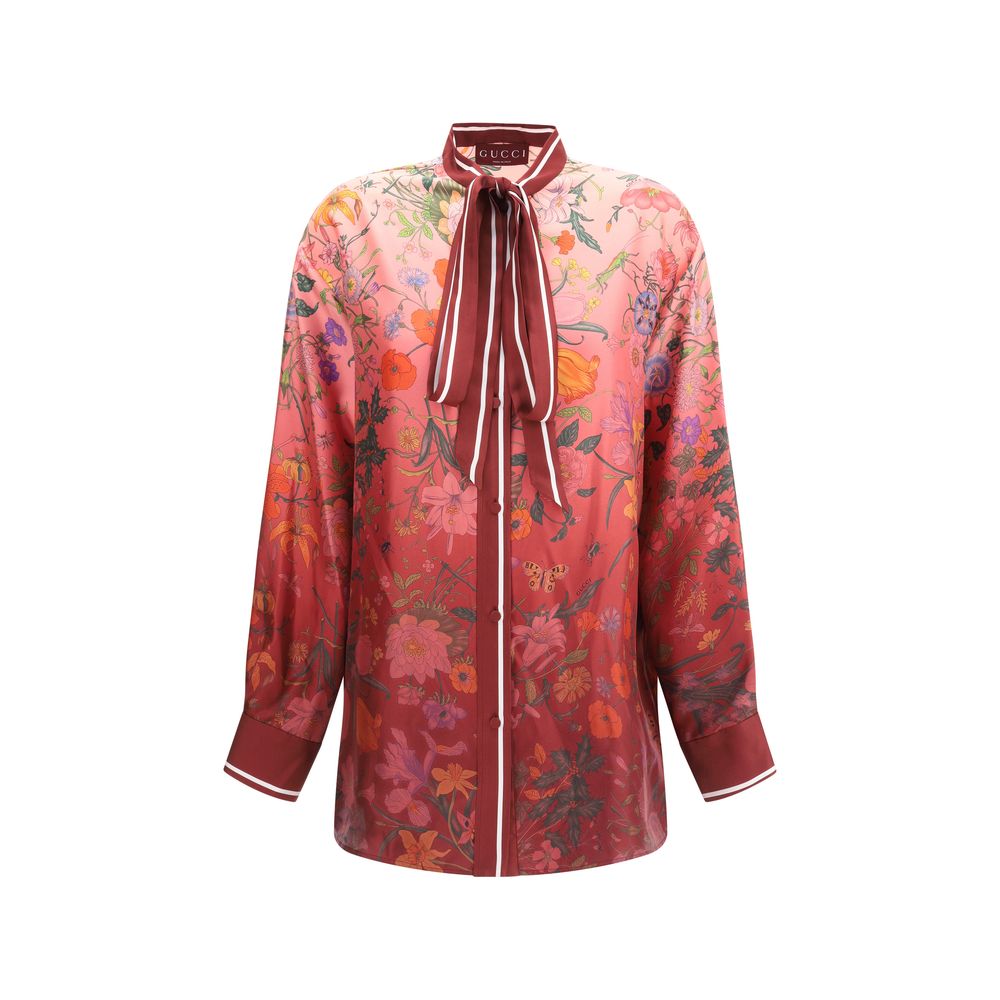 Multicolor Silk Pattern ShirtGucci’s Silk Floral Shirt is an elegant and refined piece embellished with a vibrant all-over botanical print. The collar with decorative bow, red piping and hidden buttons enhance the design, while the coordinating cuffs add