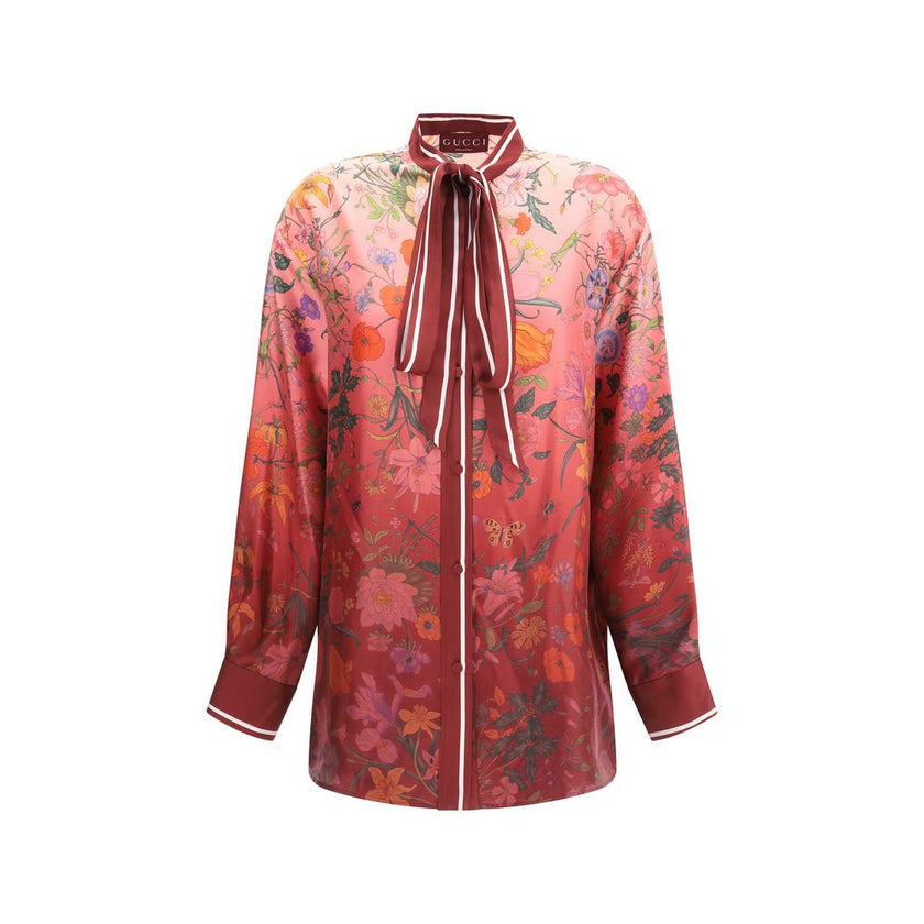 Multicolor Silk Pattern ShirtGucci’s Silk Floral Shirt is an elegant and refined piece embellished with a vibrant all-over botanical print. The collar with decorative bow, red piping and hidden buttons enhance the design, while the coordinating cuffs add
