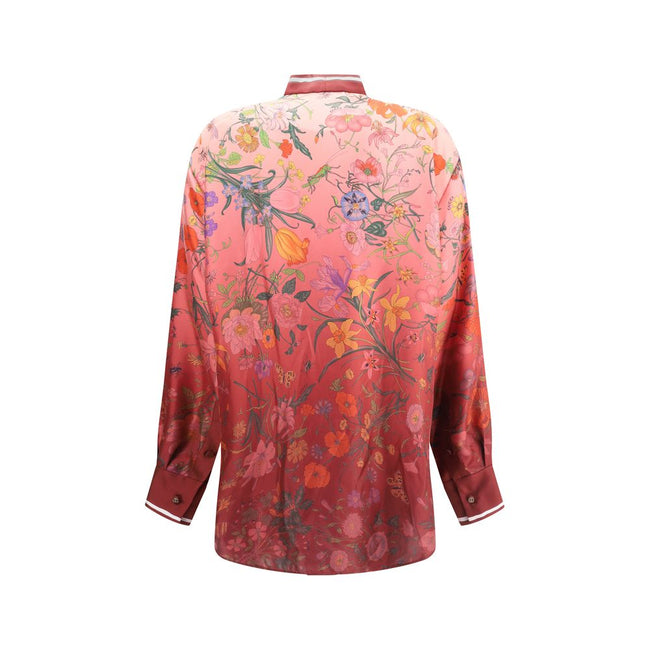 Multicolor Silk Pattern ShirtGucci’s Silk Floral Shirt is an elegant and refined piece embellished with a vibrant all-over botanical print. The collar with decorative bow, red piping and hidden buttons enhance the design, while the coordinating cuffs add