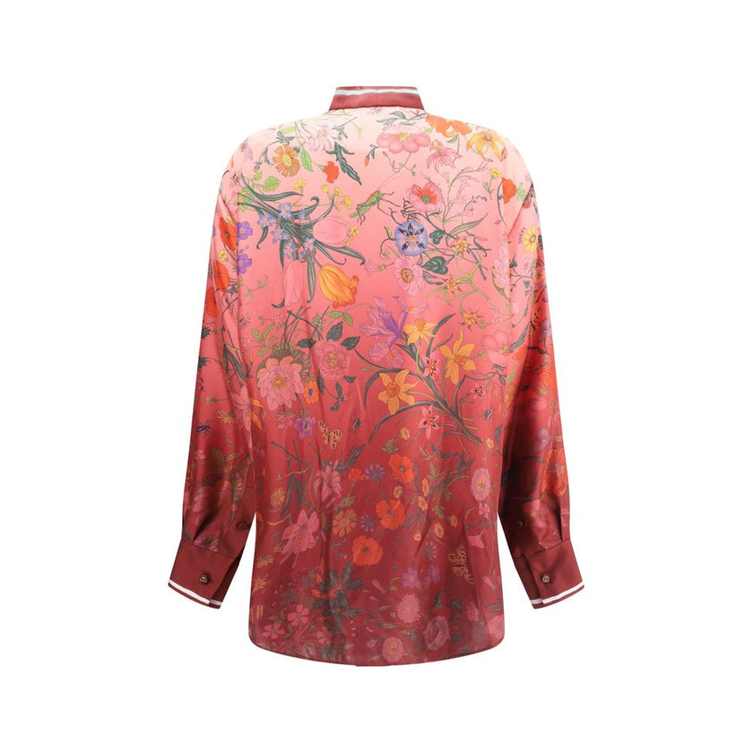 Multicolor Silk Pattern ShirtGucci’s Silk Floral Shirt is an elegant and refined piece embellished with a vibrant all-over botanical print. The collar with decorative bow, red piping and hidden buttons enhance the design, while the coordinating cuffs add