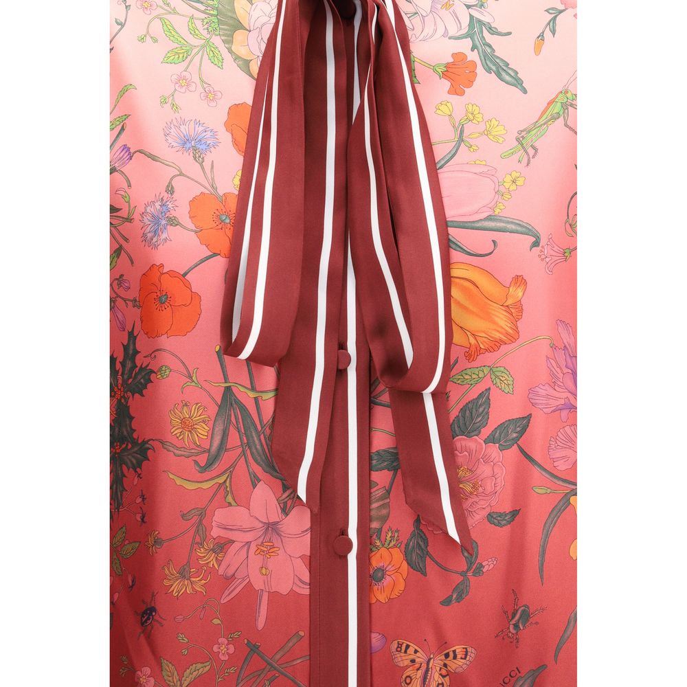 Multicolor Silk Pattern ShirtGucci’s Silk Floral Shirt is an elegant and refined piece embellished with a vibrant all-over botanical print. The collar with decorative bow, red piping and hidden buttons enhance the design, while the coordinating cuffs add