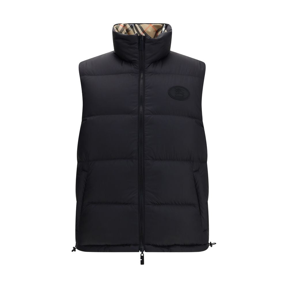 Black Polyester Sleveless JacketThe Reversible Puffer Gilet by Burberry is a versatile piece that combines functionality with iconic style. Padded with goose down and feathers, it ensures warmth and lightness. The reversible design shifts from the signatu