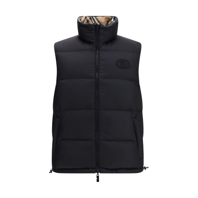 Black Polyester Sleveless JacketThe Reversible Puffer Gilet by Burberry is a versatile piece that combines functionality with iconic style. Padded with goose down and feathers, it ensures warmth and lightness. The reversible design shifts from the signatu