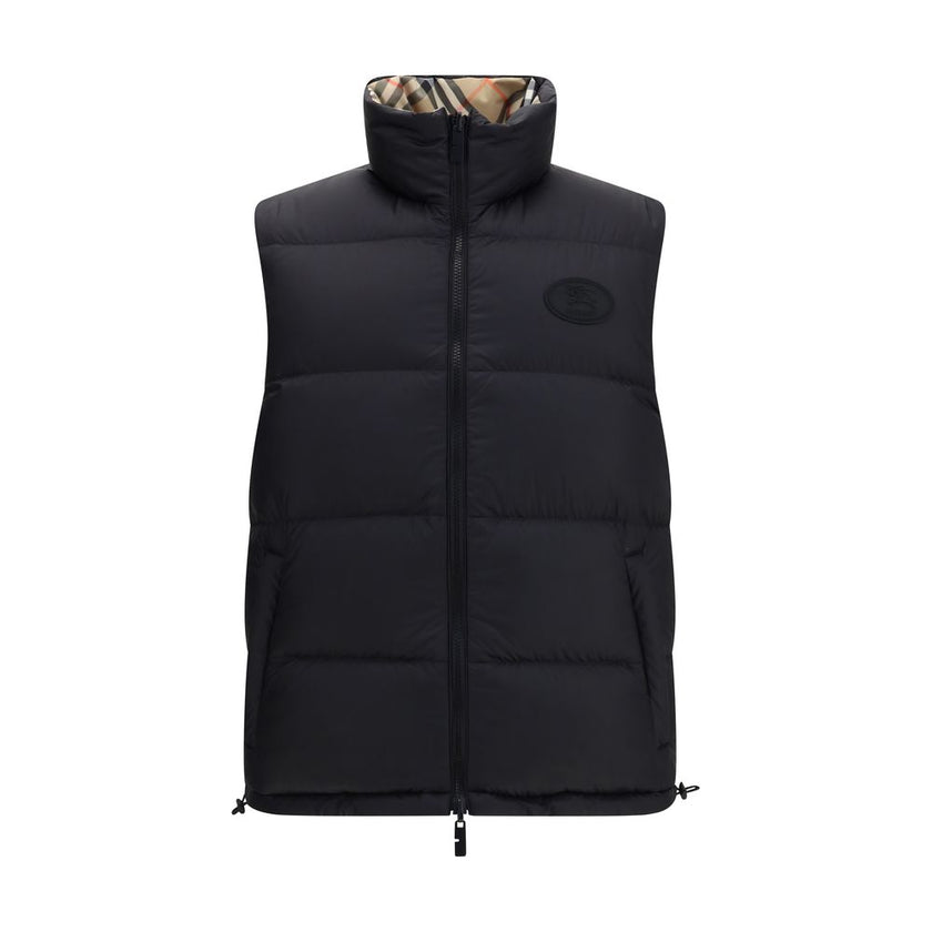 Black Polyester Sleveless JacketThe Reversible Puffer Gilet by Burberry is a versatile piece that combines functionality with iconic style. Padded with goose down and feathers, it ensures warmth and lightness. The reversible design shifts from the signatu