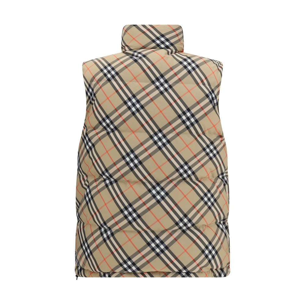 Black Polyester Sleveless JacketThe Reversible Puffer Gilet by Burberry is a versatile piece that combines functionality with iconic style. Padded with goose down and feathers, it ensures warmth and lightness. The reversible design shifts from the signatu