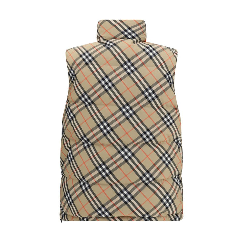 Black Polyester Sleveless JacketThe Reversible Puffer Gilet by Burberry is a versatile piece that combines functionality with iconic style. Padded with goose down and feathers, it ensures warmth and lightness. The reversible design shifts from the signatu