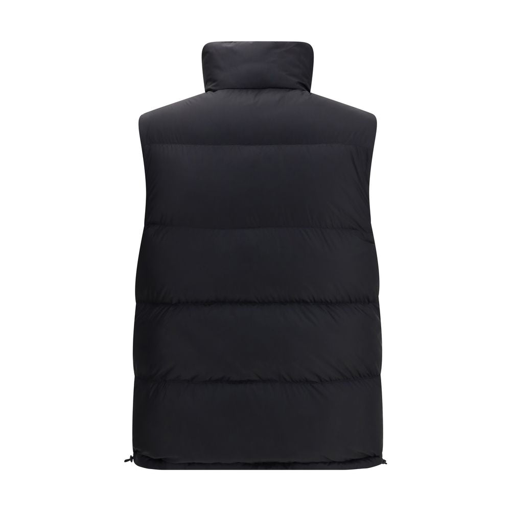 Black Polyester Sleveless JacketThe Reversible Puffer Gilet by Burberry is a versatile piece that combines functionality with iconic style. Padded with goose down and feathers, it ensures warmth and lightness. The reversible design shifts from the signatu