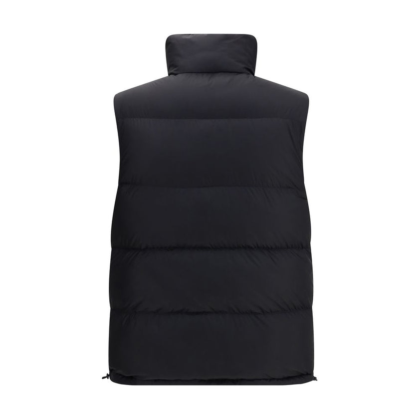 Black Polyester Sleveless JacketThe Reversible Puffer Gilet by Burberry is a versatile piece that combines functionality with iconic style. Padded with goose down and feathers, it ensures warmth and lightness. The reversible design shifts from the signatu