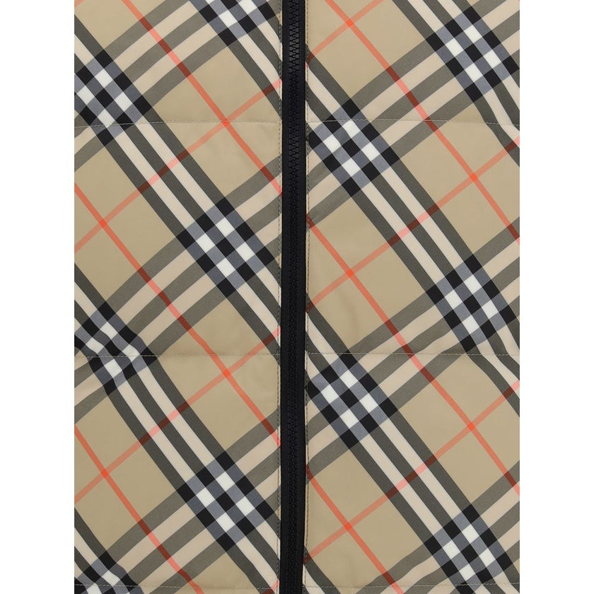 Black Polyester Sleveless JacketThe Reversible Puffer Gilet by Burberry is a versatile piece that combines functionality with iconic style. Padded with goose down and feathers, it ensures warmth and lightness. The reversible design shifts from the signatu