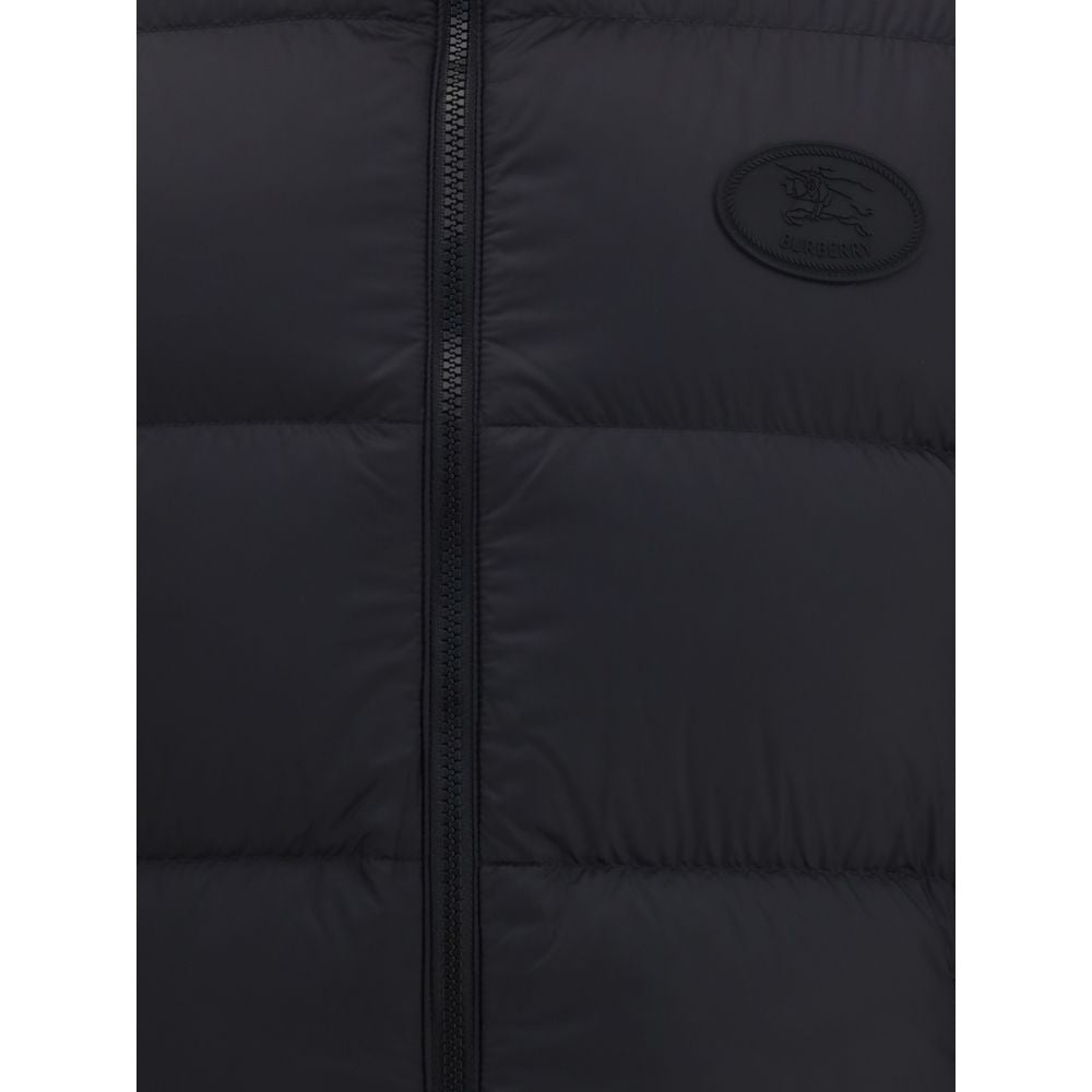 Black Polyester Sleveless JacketThe Reversible Puffer Gilet by Burberry is a versatile piece that combines functionality with iconic style. Padded with goose down and feathers, it ensures warmth and lightness. The reversible design shifts from the signatu