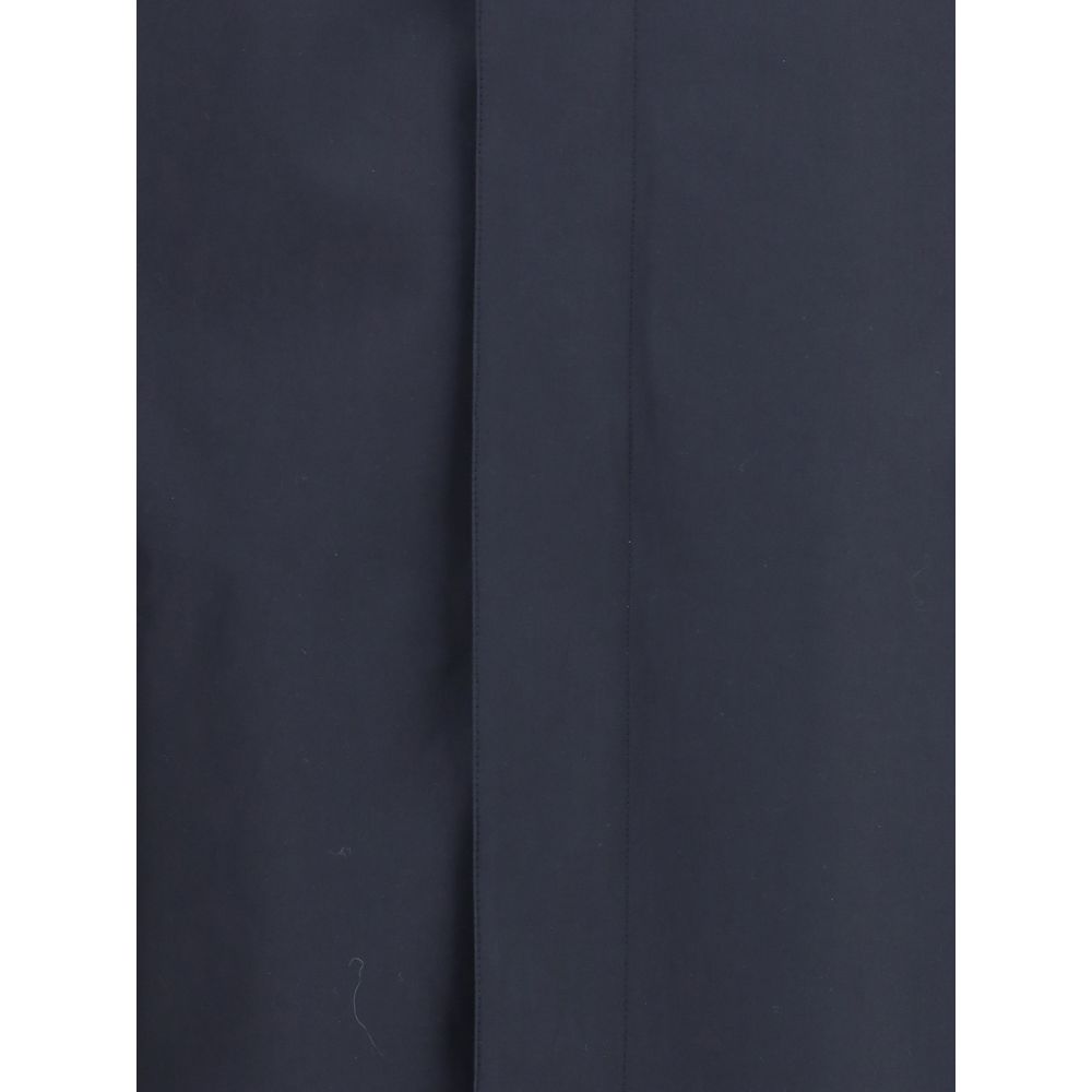 Blue Cotton CoatThe Camden Heritage Coat by Burberry is the original car coat, crafted in England from shower-resistant cotton gabardine. Part of the Heritage Collection, it features a mid-length cut with a regular fit and raglan sleeves. The single-breas