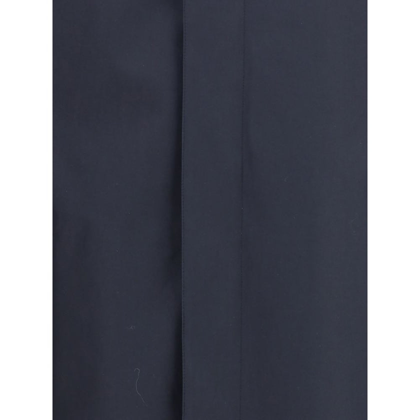 Blue Cotton CoatThe Camden Heritage Coat by Burberry is the original car coat, crafted in England from shower-resistant cotton gabardine. Part of the Heritage Collection, it features a mid-length cut with a regular fit and raglan sleeves. The single-breas