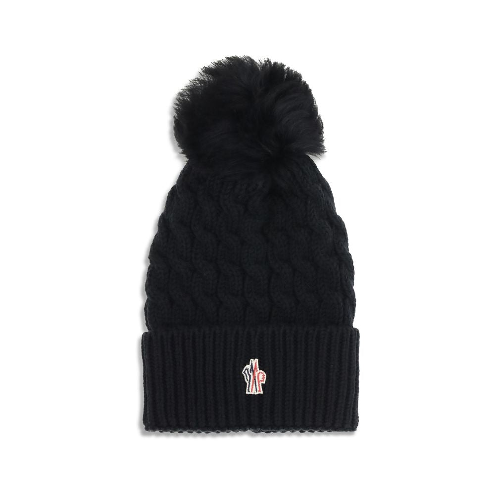 Black Fleece Wool BeanieBeanie Hat by Moncler Grenoble is made of extra fine wool yarn, ideal for ensuring warmth and comfort during the cold season. Distinguished by a refined braided knit with fineness 3, it is embellished with a matching pom-pom and co