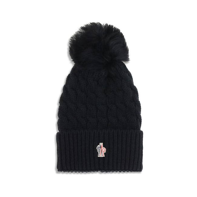 Black Fleece Wool BeanieBeanie Hat by Moncler Grenoble is made of extra fine wool yarn, ideal for ensuring warmth and comfort during the cold season. Distinguished by a refined braided knit with fineness 3, it is embellished with a matching pom-pom and co
