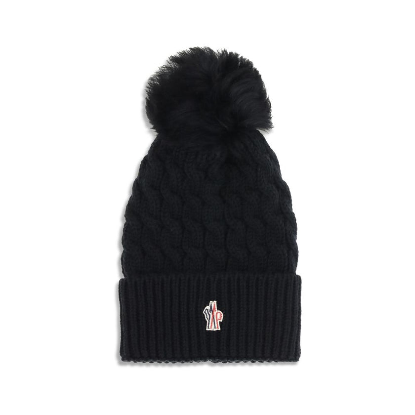 Black Fleece Wool BeanieBeanie Hat by Moncler Grenoble is made of extra fine wool yarn, ideal for ensuring warmth and comfort during the cold season. Distinguished by a refined braided knit with fineness 3, it is embellished with a matching pom-pom and co