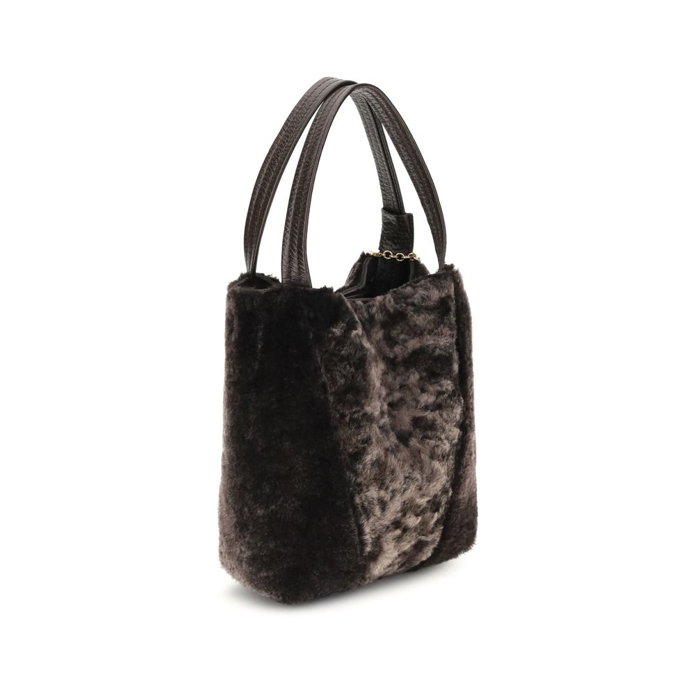 Brown Fur Shoulder BagSpin small Tote Bag by Chloè in soft shearling is distinguished by a compact, minimalist silhouette defined by clean graphic lines. The discreet elegance of the design is enhanced by a dangling chain with the iconic Chloé medals and
