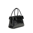 Black Calf Leather Bos Taurus HandbagSolitaire Handbag by Miu Miu combines structured lines and refined details, inspired by the maison’s 2006 archives. Made of shiny calfskin, it blends classic elegance and contemporary spirit, enhanced by the front leat