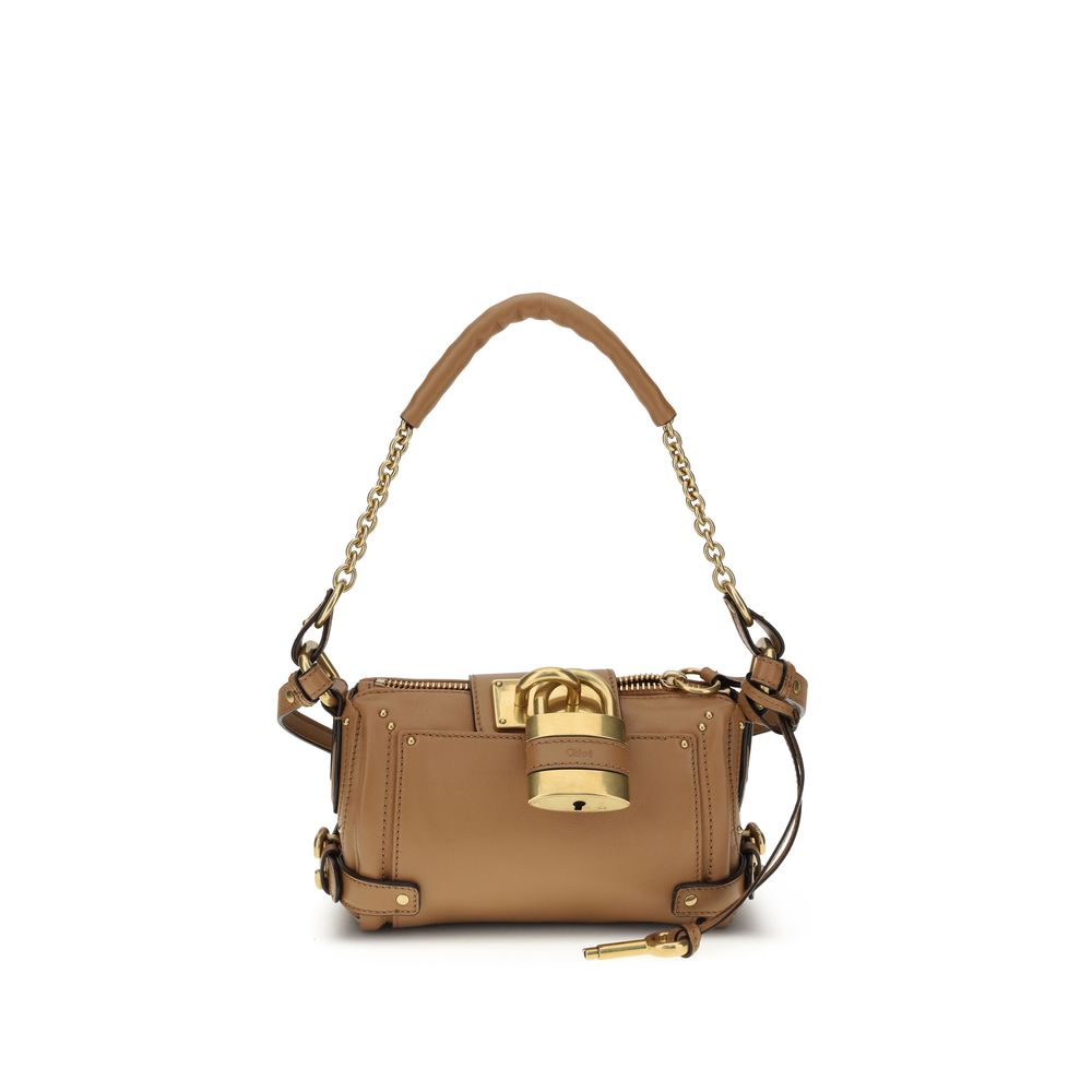 Brown Calf Leather Bos Taurus Shoulder BagPaddington Shoulder Bag by Chloé, crafted from soft garnet buffalo leather, stands out for its compact and flexible silhouette. Featuring a practical top zipper, it is embellished with iconic details such as an ov